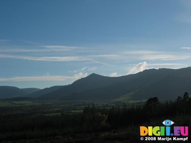 24357 Sun on fields by mountains